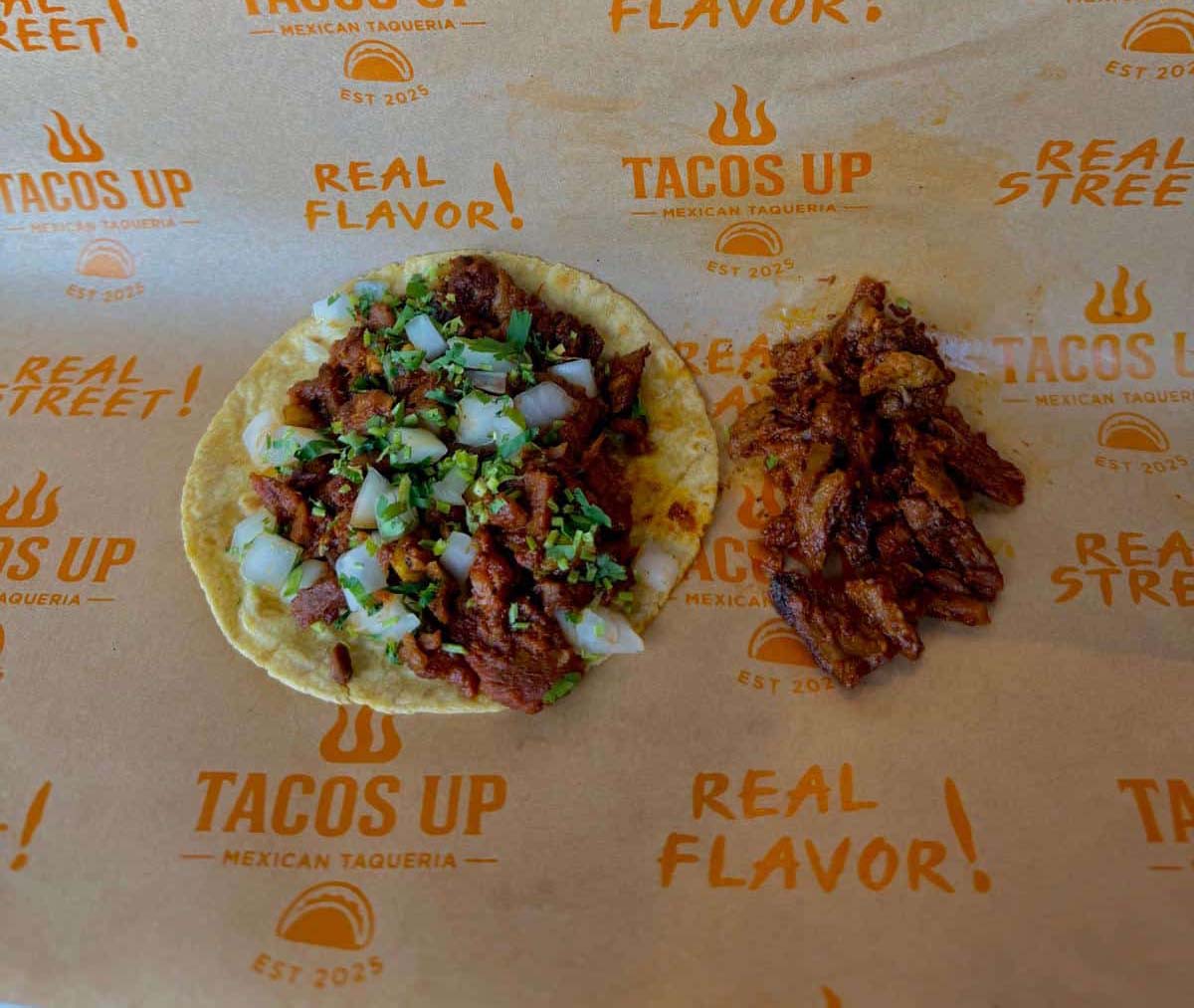 Al pastor taco close-up with cilantro and onion